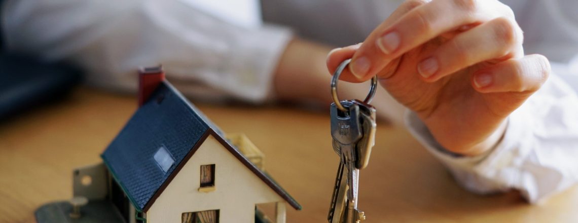 A closeup shot of a person thinking of buying or selling a house